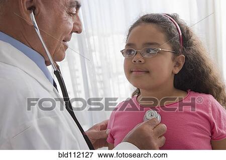 Stock Photo - Hispanic doctor checking patient's heartbeat. Fotosearch