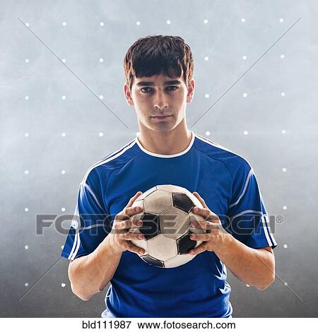 Hispanic soccer player holding ball View Large Photo Image Stock Photo - Hispanic soccer player holding ball. Fotosearch