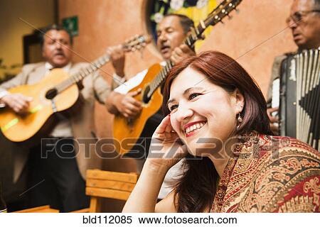 Hispanic woman in restaurant with traditional band View Large Photo Image Stock Photography - Hispanic woman in restaurant with traditional band. Fotosearch