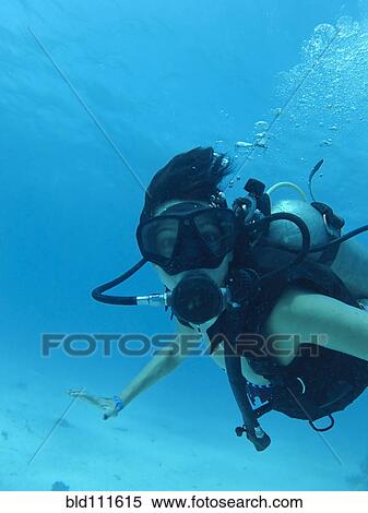 Stock Photography - Hispanic woman scuba diving. Fotosearch