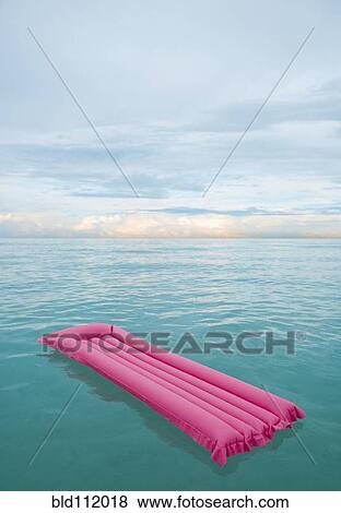 Stock Photo - Inflatable raft floating in tropical water. Fotosearch