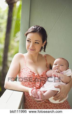 Mixed race mother cradling baby View Large Photo Image Stock Photography - Mixed race mother cradling baby. Fotosearch
