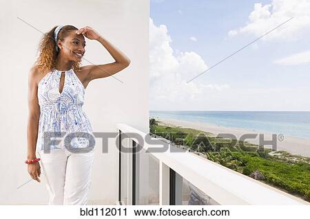 Mixed race woman overlooking beach View Large Photo Image Stock Image - Mixed race woman overlooking beach. Fotosearch