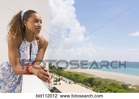 Mixed race woman overlooking beach View Large Photo Image Stock Image - Mixed race woman overlooking beach. Fotosearch