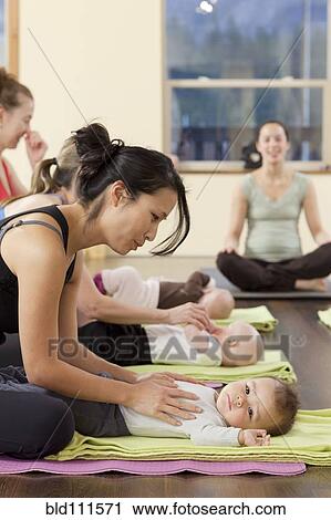 Mothers and babies taking yoga class View Large Photo Image Stock Image - Mothers and babies taking yoga class. Fotosearch