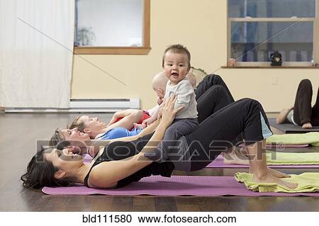 Mothers and babies taking yoga class View Large Photo Image Stock Image - Mothers and babies taking yoga class. Fotosearch
