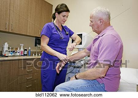 Nurse checking patient's pulse in office View Large Photo Image Stock Image - Nurse checking patient's pulse in office. Fotosearch