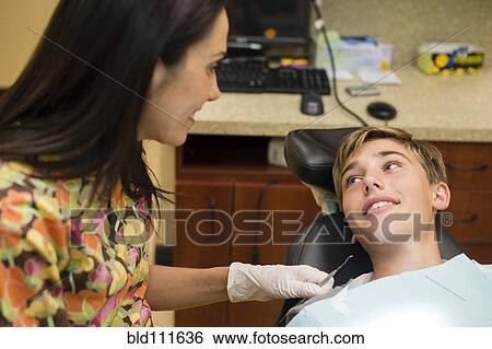 Stock Photograph - Nurse talking to dental patient. Fotosearch