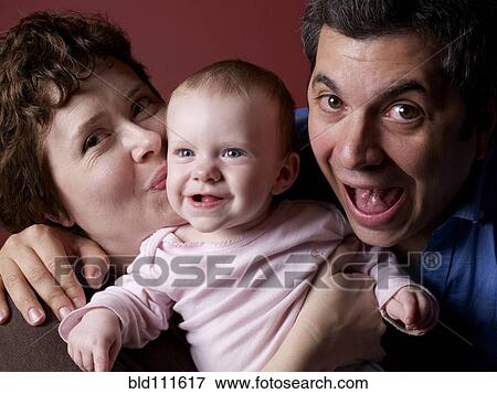 Parents smiling with baby View Large Photo Image Stock Photo - Parents smiling with baby. Fotosearch