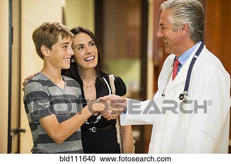 Patient shaking hands with dentist View Large Photo Image Stock Image - Patient shaking hands with dentist. Fotosearch