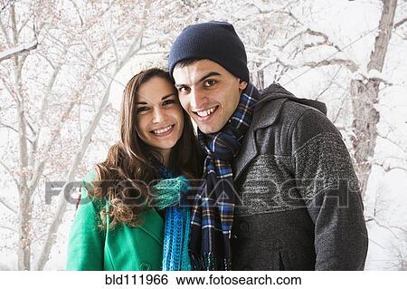 Stock Photograph - Smiling couple walking in show. Fotosearch