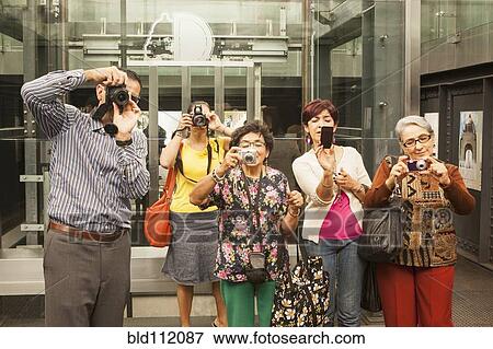 Stock Photo - Tourists taking pictures in museum. Fotosearch