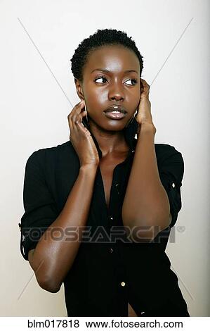 Stock Photo - African American woman holding her face. Fotosearch