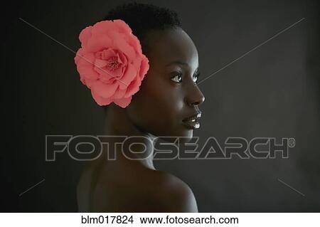 Picture - African American woman wearing flower in hair. Fotosearch