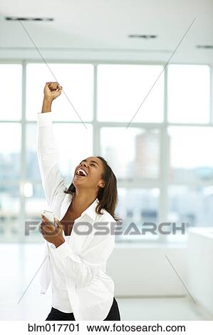 Black businesswoman cheering in office View Large Photo Image Stock Image - Black businesswoman cheering in office. Fotosearch