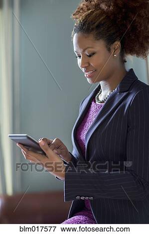 Stock Photo - Black businesswoman using tablet computer. Fotosearch