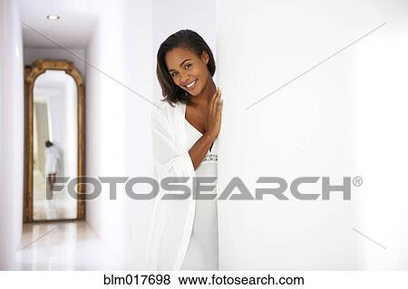 Black woman peeking out doorway View Large Photo Image Stock Photo - Black woman peeking out doorway. Fotosearch