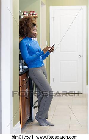 Black woman using cell phone View Large Photo Image Stock Image - Black woman using cell phone. Fotosearch