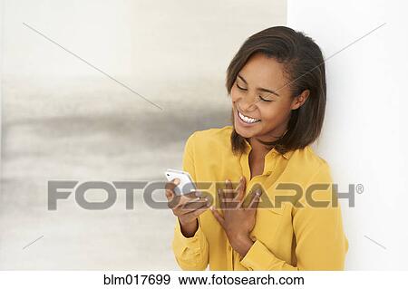 Stock Photo - Black woman using cell phone. Fotosearch