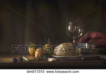 Stock Photography - Bread, fruit, wine and cheese on table. Fotosearch