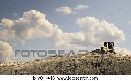 Stock Image - Bulldozer working in quarry. Fotosearch