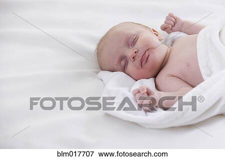 Caucasian baby sleeping on bed View Large Photo Image Stock Photo - Caucasian baby sleeping on bed. Fotosearch