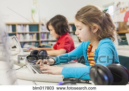 Caucasian children using laptops in library View Large Photo Image Stock Image - Caucasian children using laptops in library. Fotosearch