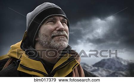 Stock Photo - Caucasian man standing in snowy landscape. Fotosearch