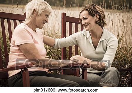 Caucasian mother and daughter talking outdoors View Large Photo Image Stock Photograph - Caucasian mother and daughter talking outdoors. Fotosearch