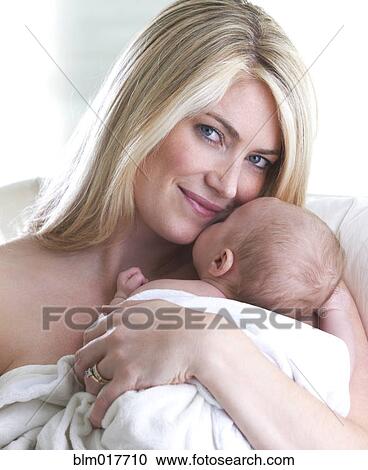 Caucasian mother cradling baby View Large Photo Image Stock Image - Caucasian mother cradling baby. Fotosearch