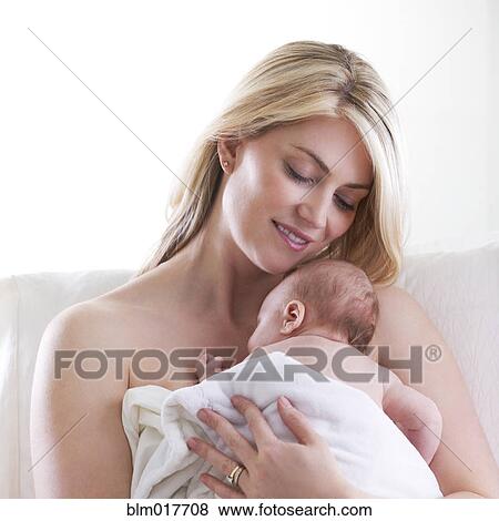 Stock Photo - Caucasian mother cradling baby. Fotosearch