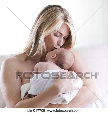 Caucasian mother kissing baby View Large Photo Image Stock Photo - Caucasian mother kissing baby. Fotosearch