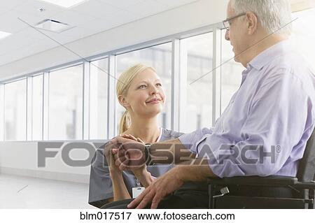 Caucasian nurse talking to patient in hospital View Large Photo Image Stock Photo - Caucasian nurse talking to patient in hospital. Fotosearch
