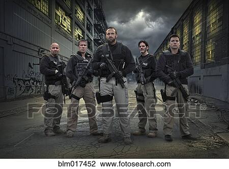 Stock Image - Caucasian policemen on city street. Fotosearch