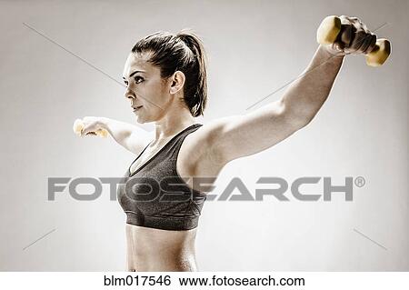 Stock Photograph - Caucasian woman lifting weights. Fotosearch