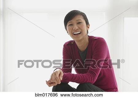 Chinese businesswoman smiling in office View Large Photo Image Stock Photograph - Chinese businesswoman smiling in office. Fotosearch