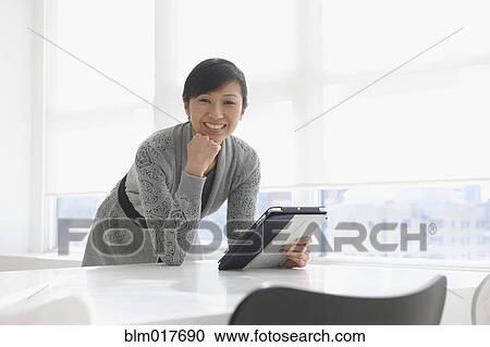 Chinese businesswoman using tablet computer View Large Photo Image Stock Image - Chinese businesswoman using tablet computer. Fotosearch