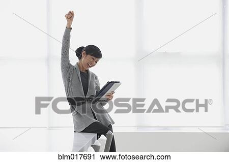 Stock Image - Chinese businesswoman using tablet computer. Fotosearch