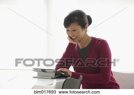 Chinese businesswoman using tablet computer View Large Photo Image Stock Image - Chinese businesswoman using tablet computer. Fotosearch