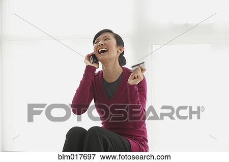 Chinese woman shopping on telephone View Large Photo Image Stock Photo - Chinese woman shopping on telephone. Fotosearch
