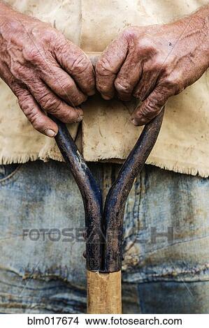 Close up of older man's hands holding shovel View Large Photo Image Picture - Close up of older man's hands holding shovel. Fotosearch