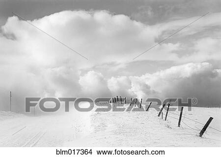 Clouds and wooden fence in snowy landscape View Large Photo Image Picture - Clouds and wooden fence in snowy landscape. Fotosearch