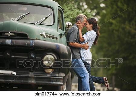 Couple kissing by truck outdoors View Large Photo Image Picture - Couple kissing by truck outdoors. Fotosearch