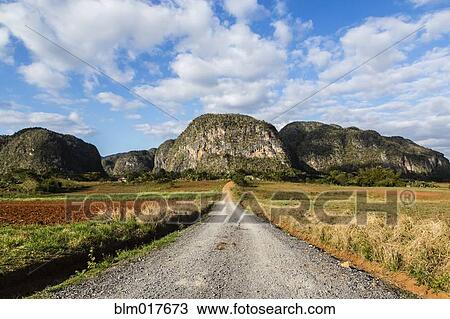 Dirt road leading to mountains in rural landscape View Large Photo Image Stock Image - Dirt road leading to mountains in rural landscape. Fotosearch
