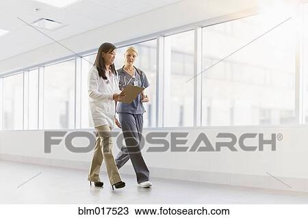 Doctor and nurse talking in hospital View Large Photo Image Stock Image - Doctor and nurse talking in hospital. Fotosearch