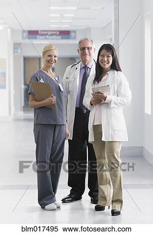 Stock Photography - Doctors and nurse smiling in hospital. Fotosearch