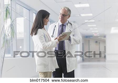 Doctors talking in hospital View Large Photo Image Picture - Doctors talking in hospital. Fotosearch