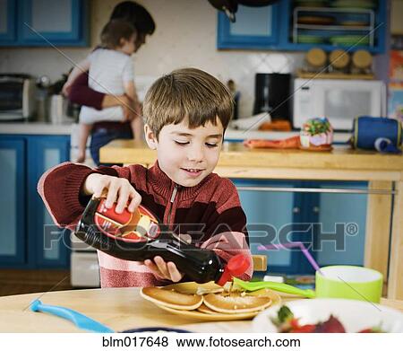 Hispanic boy having breakfast View Large Photo Image Stock Photo - Hispanic boy having breakfast. Fotosearch
