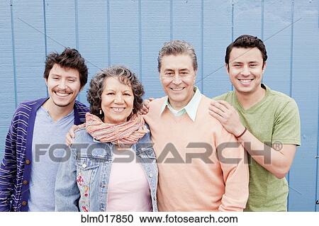 Stock Image - Hispanic family smiling outdoors. Fotosearch