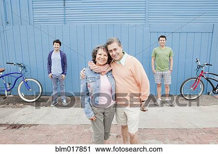 Stock Image - Hispanic family smiling outdoors. Fotosearch